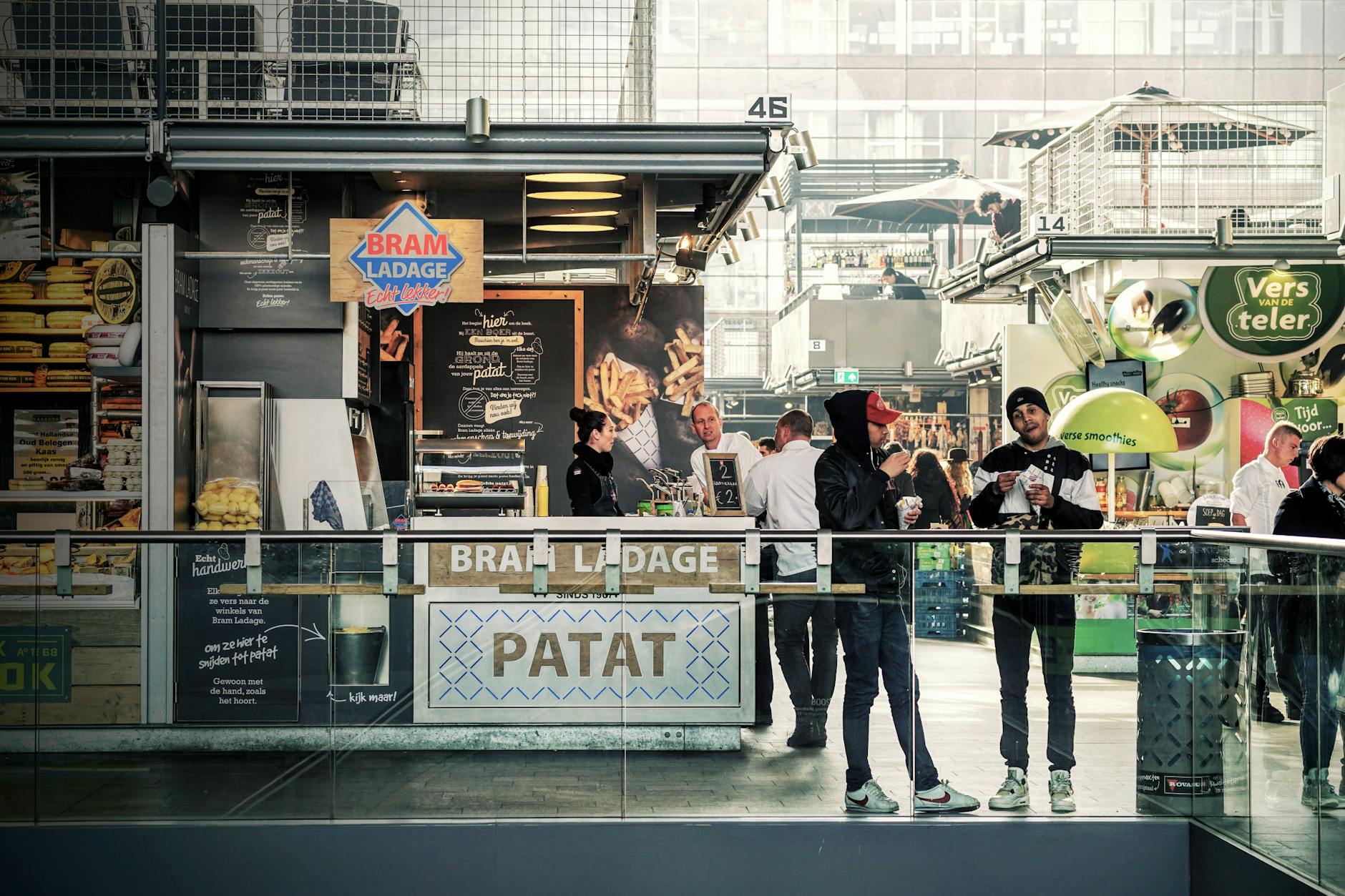 Modern industrial food hall with communal dining tables and vendors
