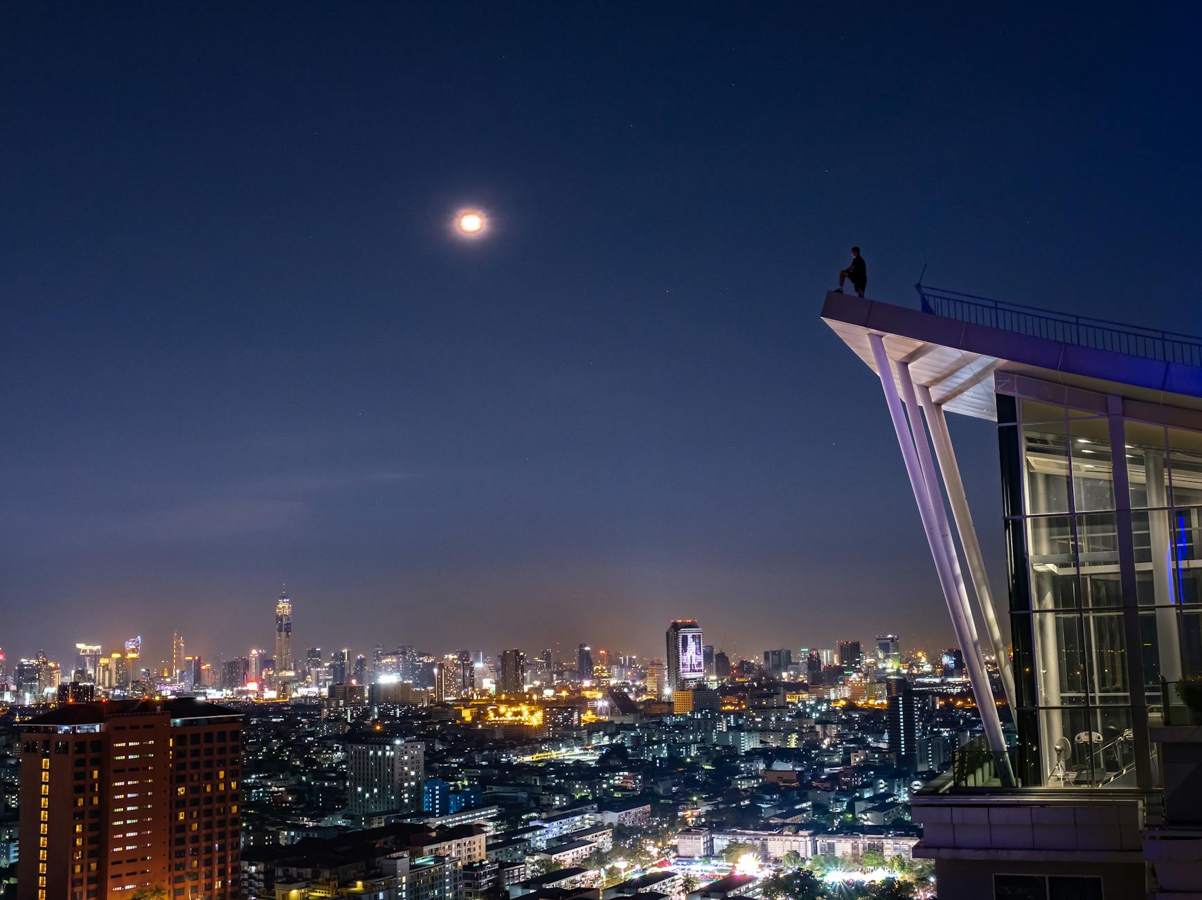 Manchester nightlife rooftop bar with city skyline view at night