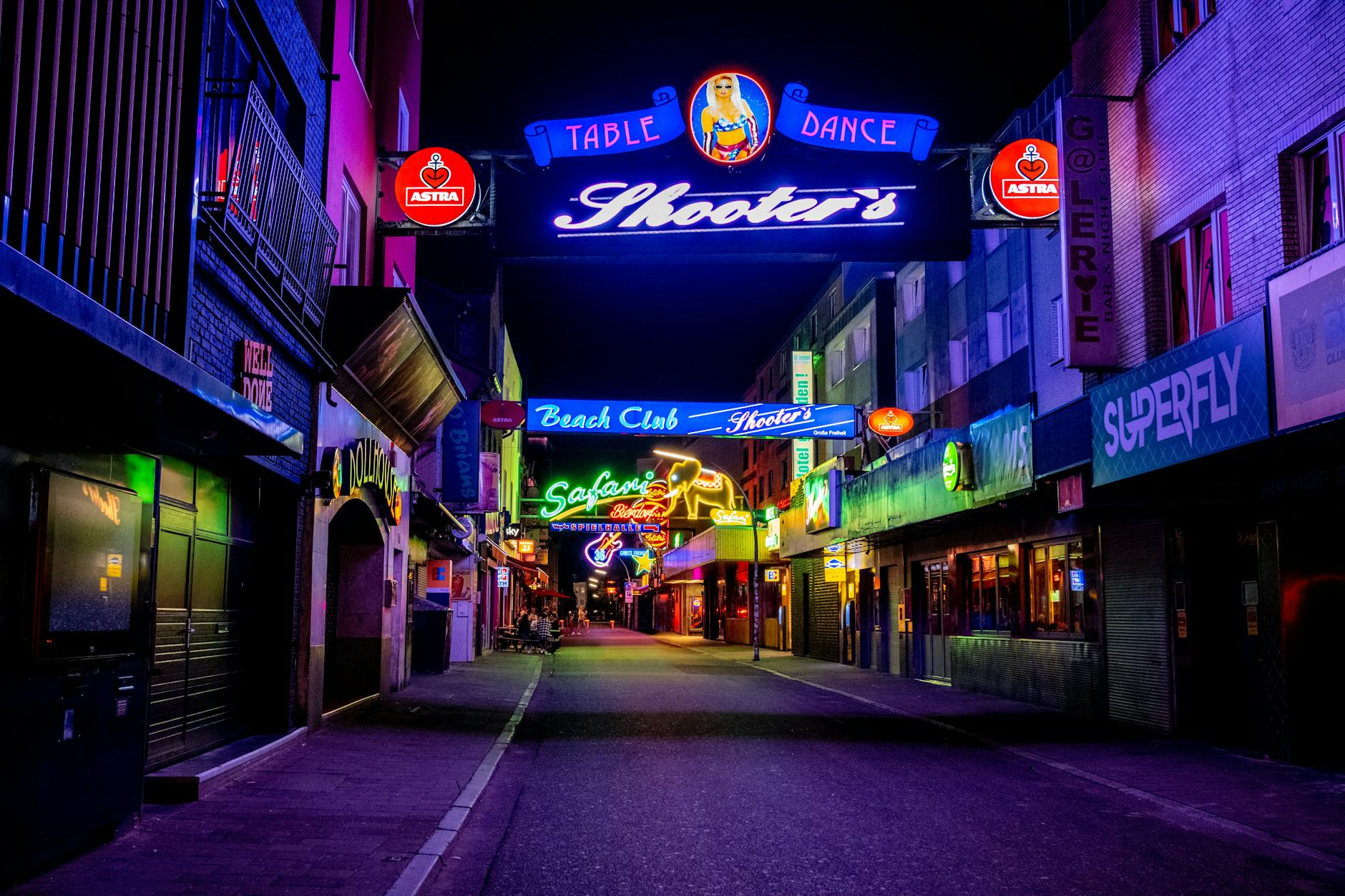 Manchester nightlife city street scene at night with neon lights and people