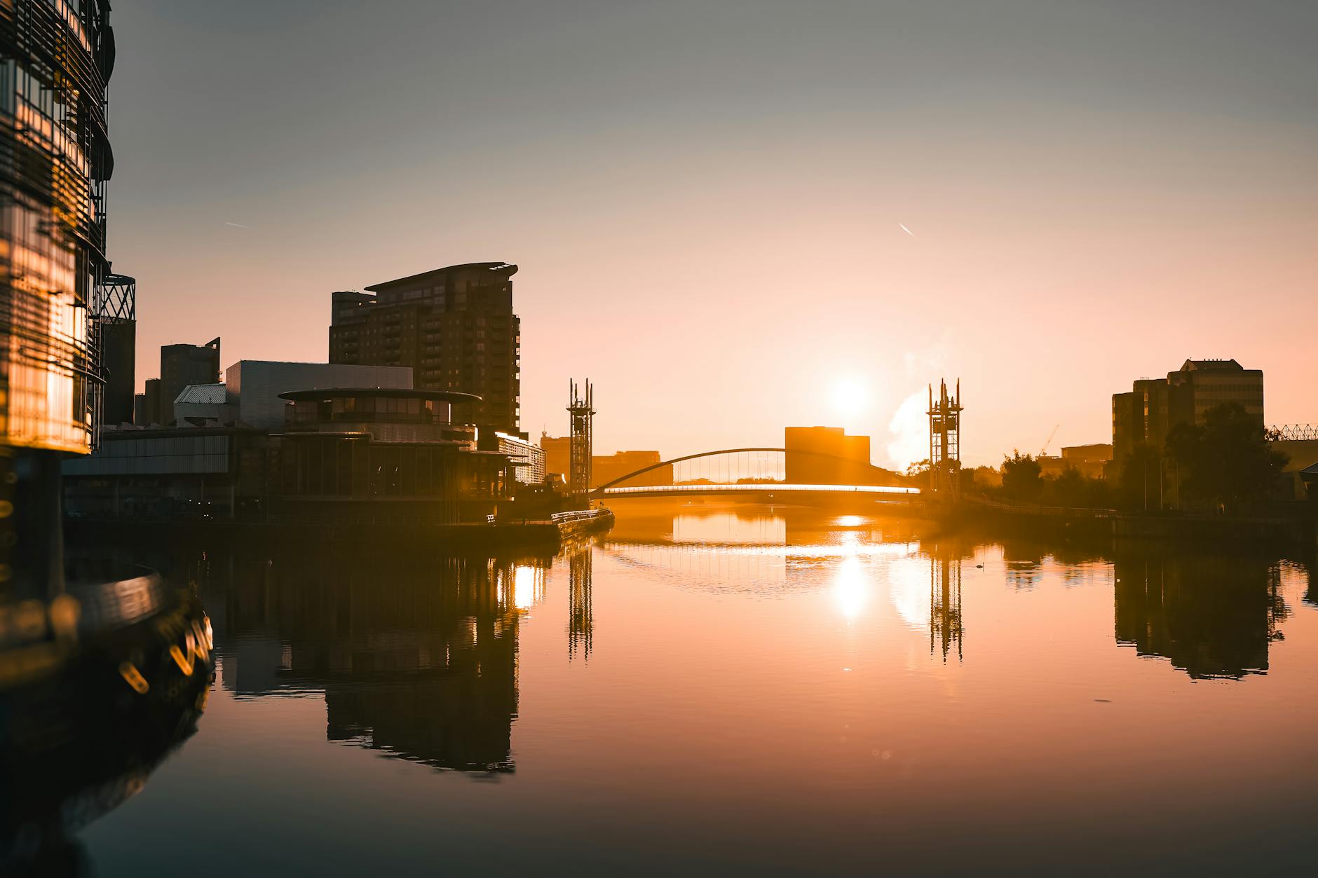 Salford Quays waterfront with modern buildings and reflections in Manchester