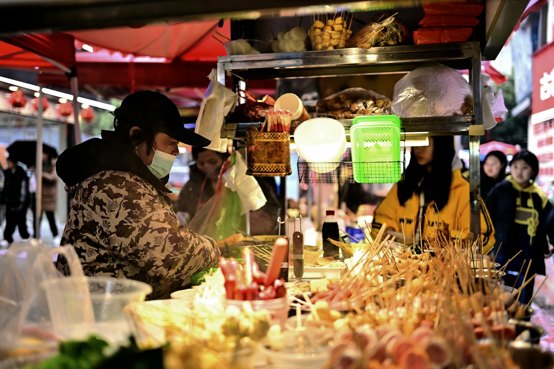 Bustling street food market with food stalls and visitors in Manchester