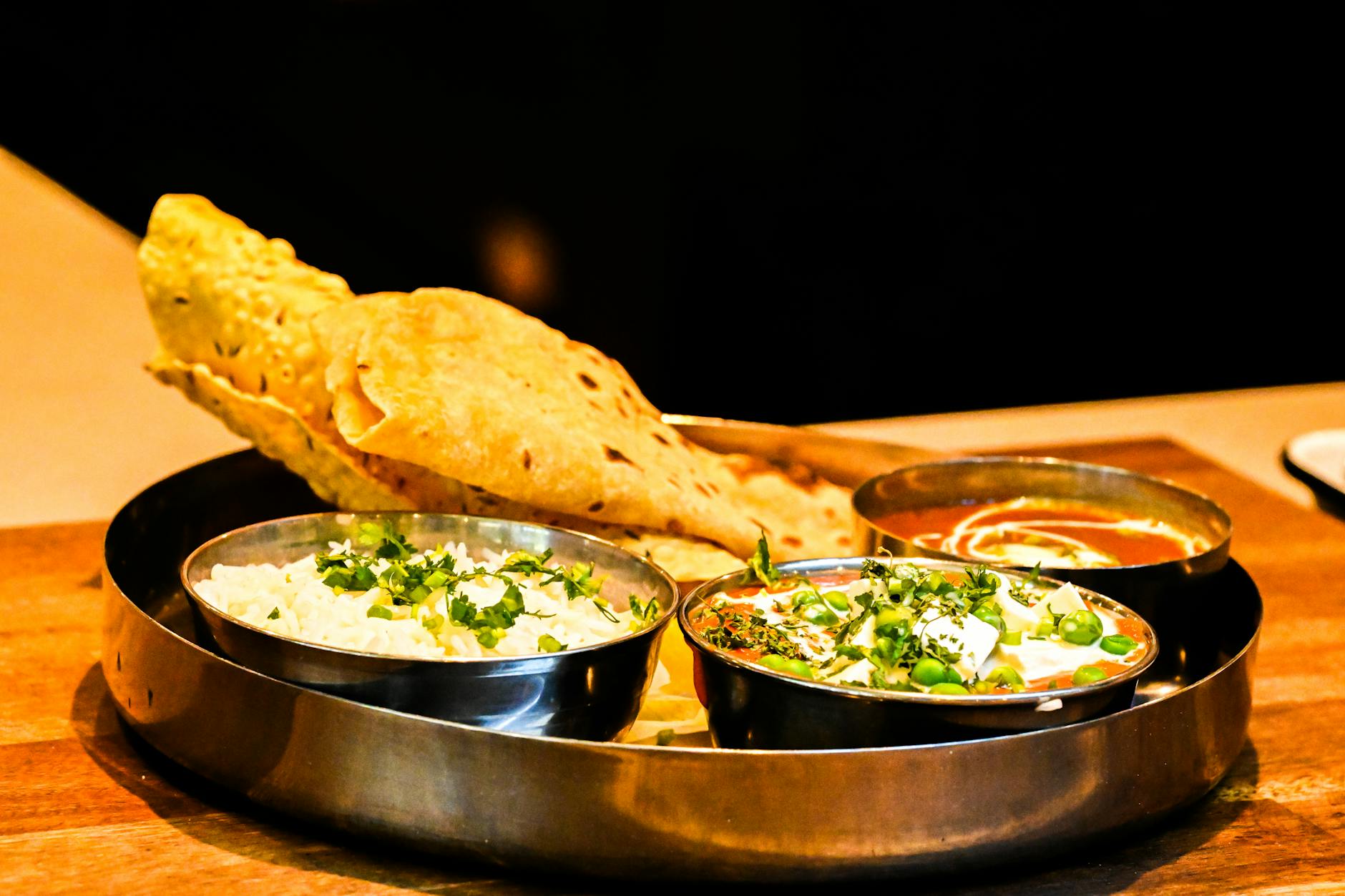 Plate of curry and rice with naan bread at Curry Mile restaurant Manchester