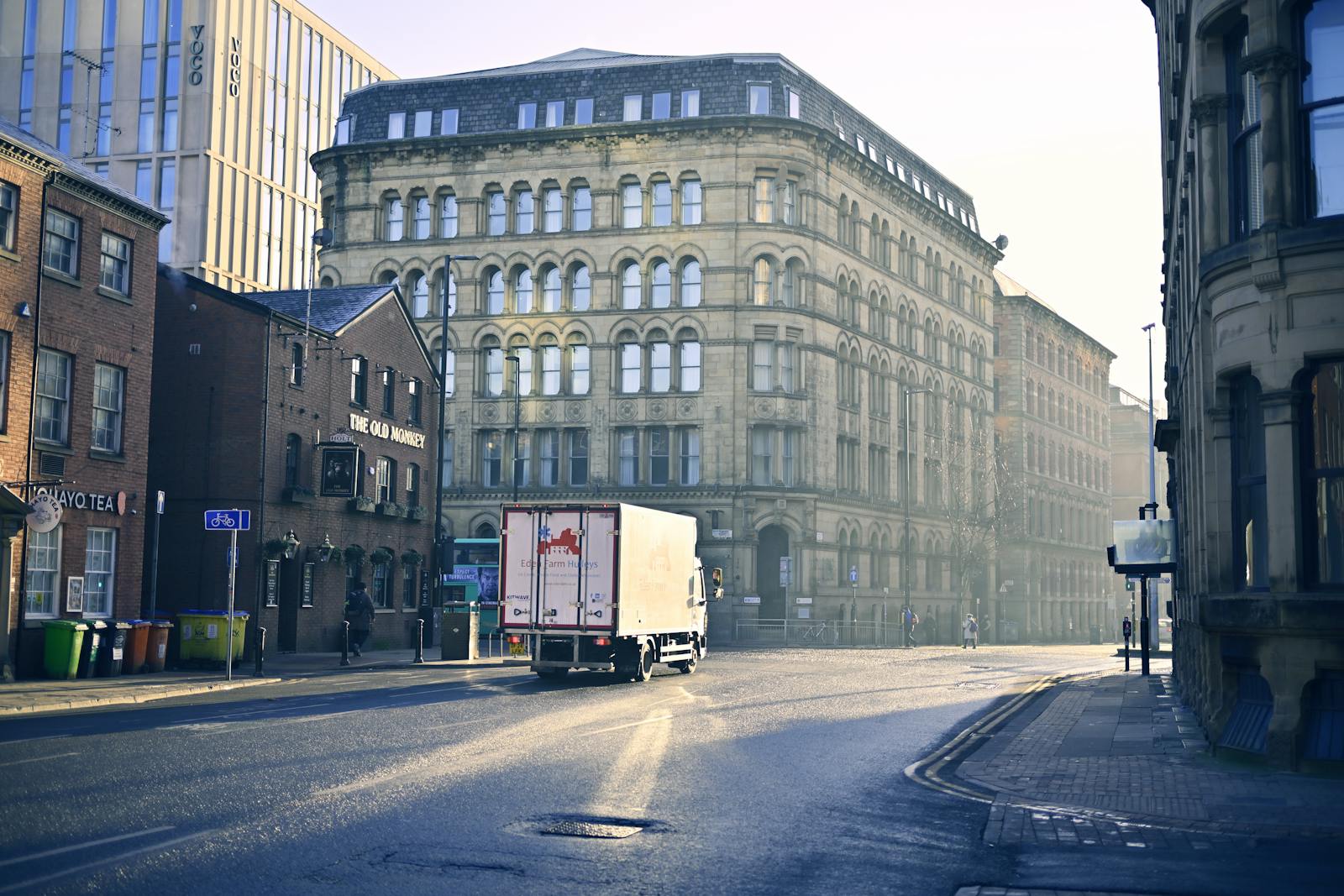 Manchester Bus Guide: Routes, Passes & the Bee Network (2026) 4 Bee Network bus on Manchester's Curry Mile in Rusholme
