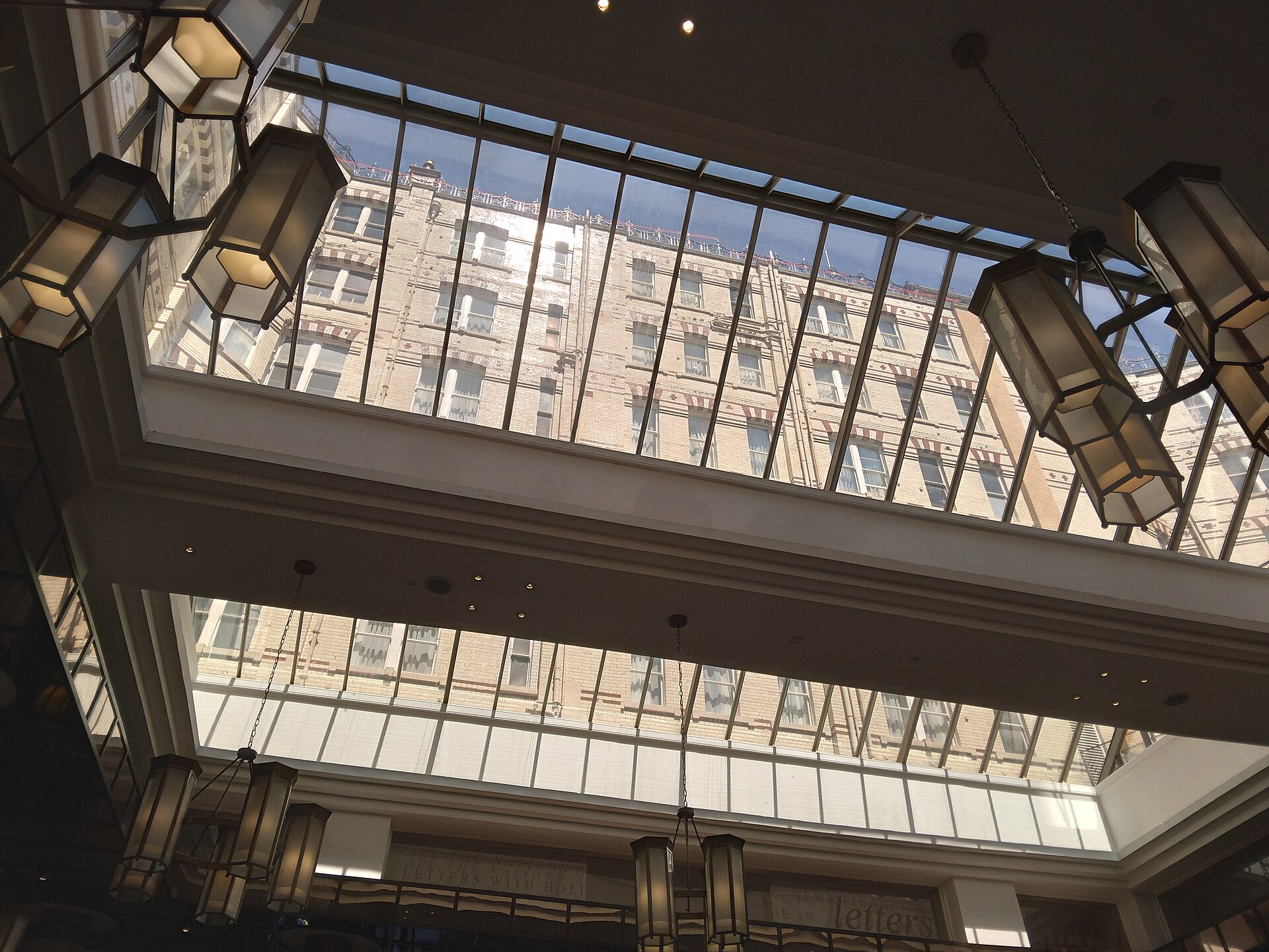 Best Afternoon Tea in Manchester: 20 Places Worth Booking 3 Looking up at the glazed atrium roof and art deco pendant lanterns inside the Midland Hotel in Manchester