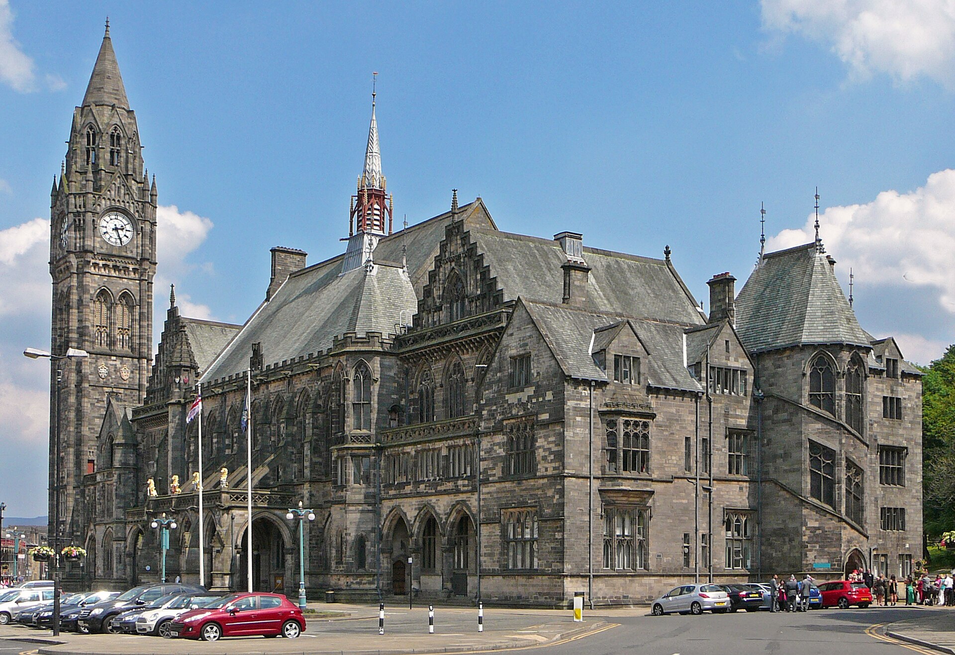 Greater Manchester Towns: The Complete Guide Beyond the City Centre 7 The Gothic stone facade and clock tower of Rochdale Town Hall under a blue sky