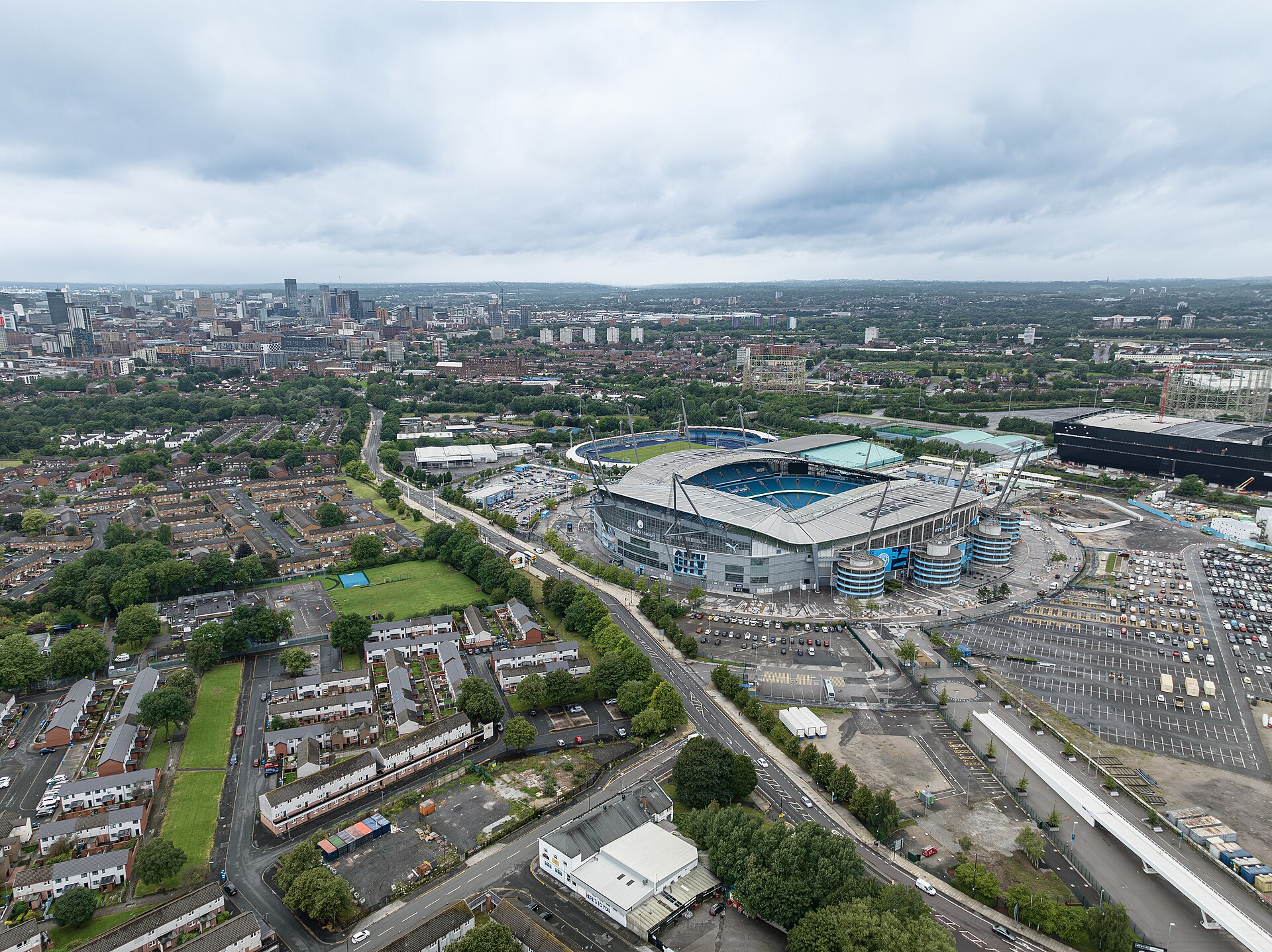 Aerial view of the Etihad Stadium in east Manchester with the city-centre skyline in the distance