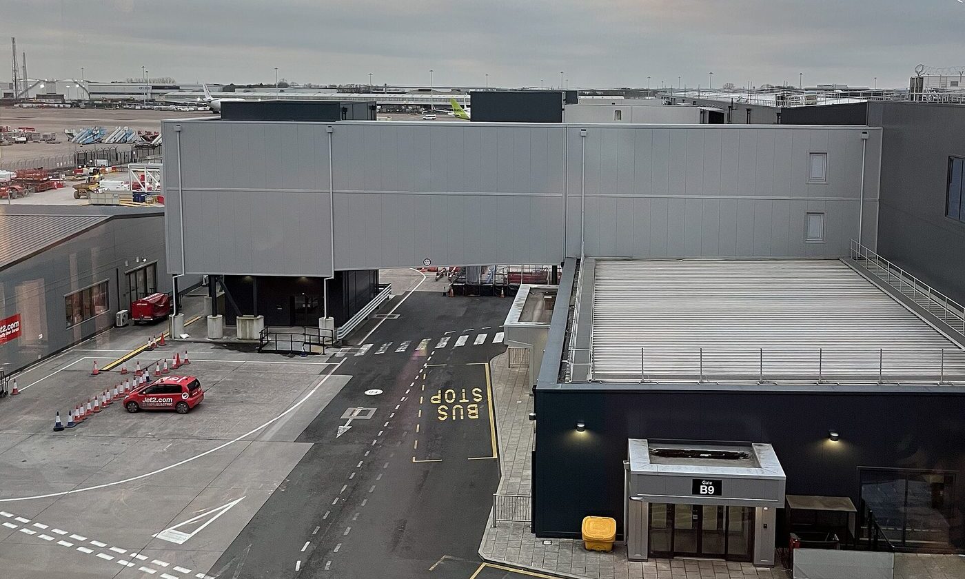 Airside view of Manchester Airport Terminal 2 showing a boarding gate and pier walkway