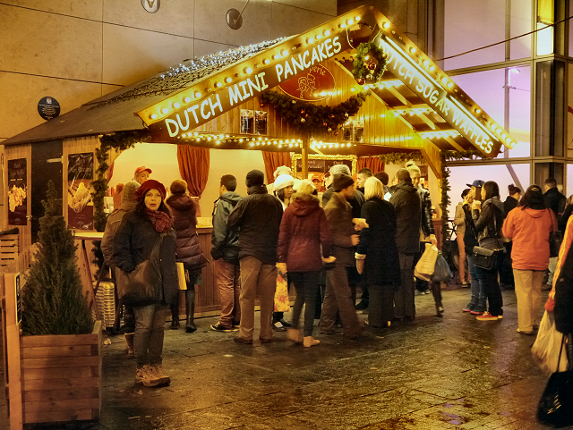 Manchester Christmas Markets Food & Drink: What to Eat & Drink 3 A crowd queuing at a Dutch mini pancakes stall at the Exchange Square Christmas market