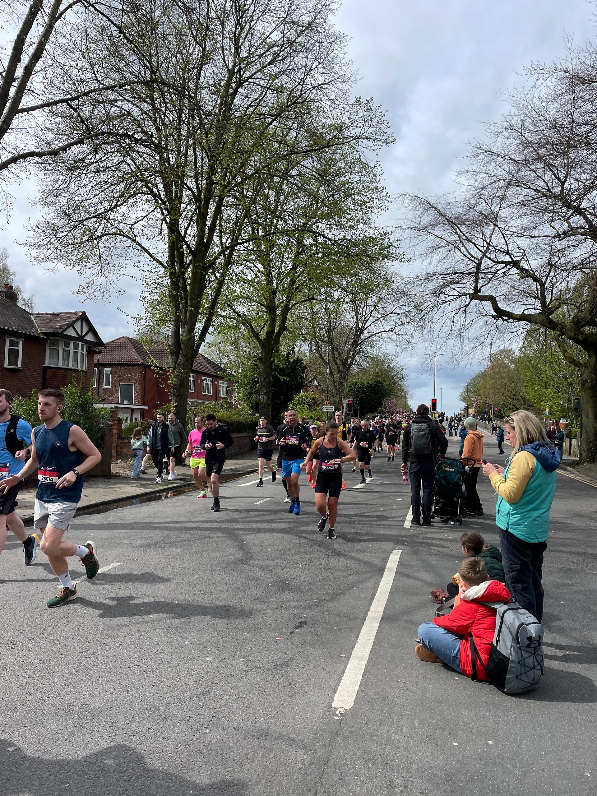 Manchester Month by Month: The Year-Round Visitor's Calendar 3 Marathon runners on a tree-lined stretch of Edge Lane in Stretford with spectators on the verge