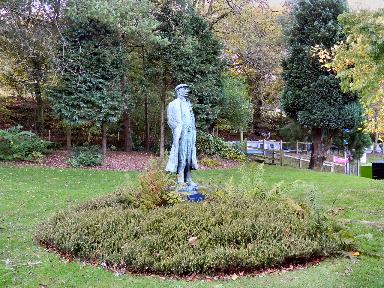 Statue of the poet Ammon Wrigley in a small garden in Uppermill