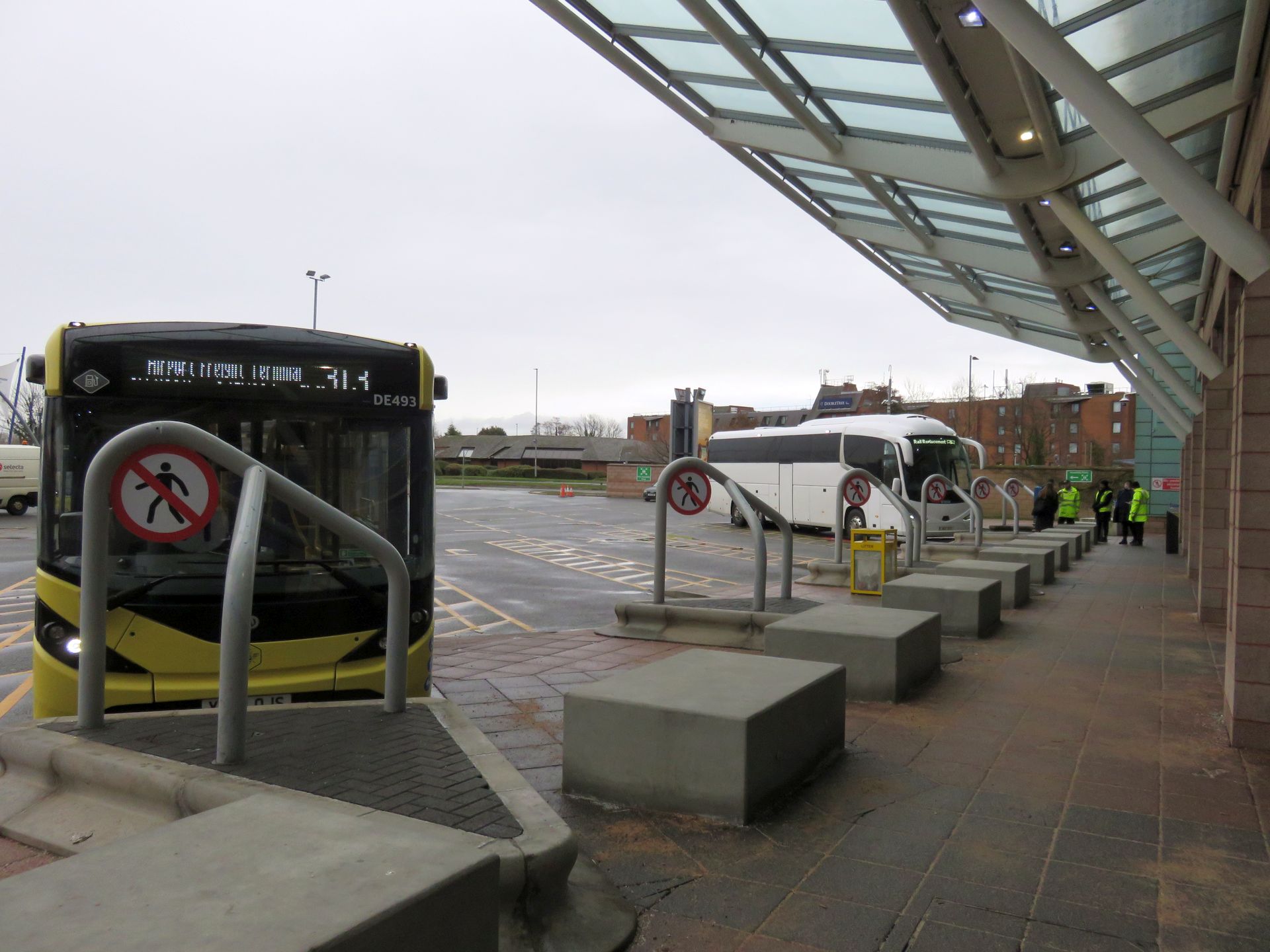 Manchester Airport Arrivals: What to Do the Moment You Land 7 A yellow Bee Network bus at a covered stand at the Manchester Airport bus station