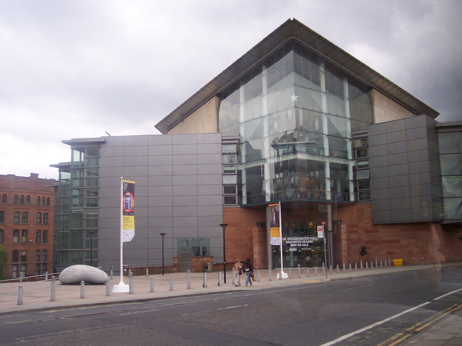Manchester in November: Weather, Events & What to Do 6 The glass and steel front of The Bridgewater Hall concert venue on a grey day